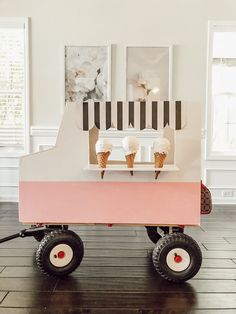 an ice cream cart with three scoops on the top and two cones on the bottom