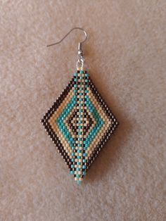 a pair of beaded earrings sitting on top of a carpet