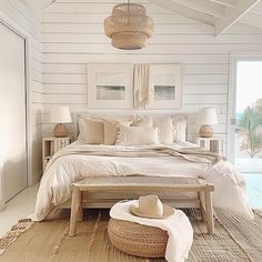 a bedroom with white walls and flooring is decorated in natural materials, such as wicker