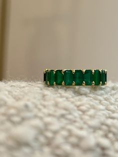 18K gold in your choice of White or Yellow 6.65 ctw (for size 6) of natural green emeralds, stones measure 5mm x 3mm U-ternity style setting Handmade in New York *If other size is needed, please indicate desired size in note box at checkout. Gold Rings With Emeralds, Emerald Gold Wedding Ring, Emerald Wedding Bands For Women, Emerald Stone Wedding Band, Green Emerald Wedding Band, Gold And Emerald Wedding Ring, Emerald Green Wedding Band, Emerald Green Rings, Emerald Green Wedding Ring