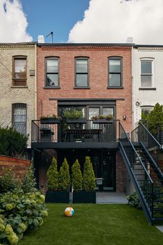 an apartment building with stairs leading up to the second floor