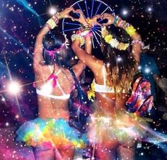 two women in bikinis are dancing on the dance floor with colorful lights and confetti all around them