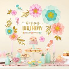 a table topped with cakes and desserts next to a sign that says happy birthday