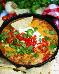 a black bowl filled with salsa and tortilla chips