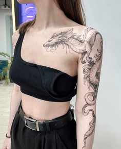 a woman with a dragon tattoo on her shoulder