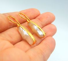 "Flat Fresh water Pearl, Drop Earrings made out of 18 karat Gold plated Sterling Silver. 100% Handmade Jewellery. PEARL: This enchanting June birthstone originates from oceans, lakes and rivers around the world. It is a timeless wardrobe staple, beloved by women of all ages. Pearls have long been associated with purity, humility and innocence. So it may be said that the June birthstone meaning is \"sweet simplicity.\" As such, pearls were traditionally given as a wedding gift. THE EARRINGS: We l Gold Gemstone Pearl Earrings For Wedding, Gold Pearl Earrings With Gemstone For Formal Occasions, Gold Pearl Earrings With Gemstones For Formal Events, Formal Gold Pearl Earrings With Gemstone, High Luster Drop Earrings For Gift, Yellow Gold Teardrop Pearl Earrings With Gemstone, Gold Drop Pearl Earrings With Gemstones, Gold Pearl Earrings With High Luster For Gift, Gold Pearl Gemstone Earrings For Anniversary