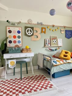 a child's bedroom with green walls and colorful decorations on the wall above it