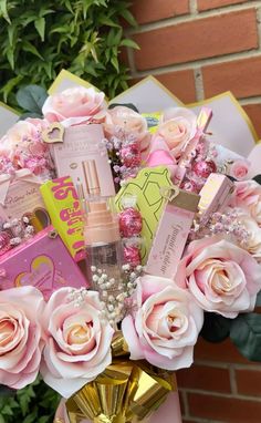 a vase filled with pink roses and cosmetics