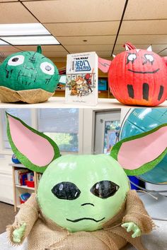 two pumpkins with faces painted to look like characters