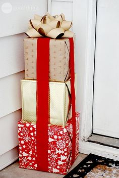 a stack of wrapped presents sitting in front of a door