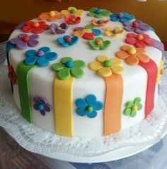 a white cake with multicolored flowers on it