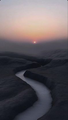 the sun is setting over a small stream