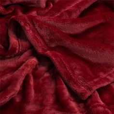 a red blanket that is laying on the ground