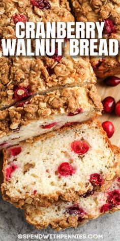 cranberry walnut bread cut into slices on a cutting board with fresh cranberries