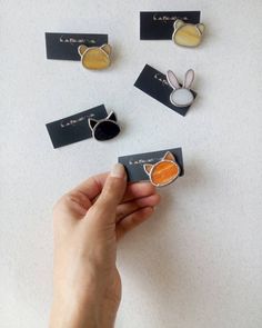 a person is holding up some business cards with bunny ears on them and an orange carrot in the middle