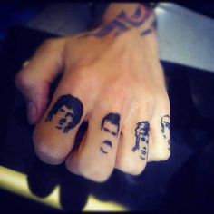 a person with some tattoos on their fingers