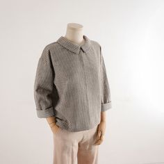 a mannequin wearing a shirt and pants on a white background with no head