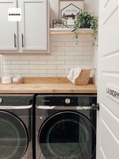 a washer and dryer sitting in a kitchen next to each other on top of a wooden counter