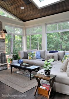 a living room filled with furniture and lots of windows