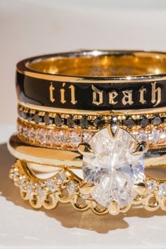 a stack of rings that have been decorated with different types of jewels and words on them