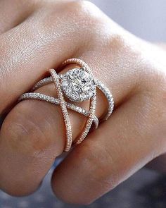 a woman's hand with a diamond ring on it