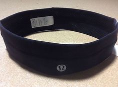 ABOVE LEFT: Notice  how the lululemon symbol is larger on the counterfeit headband. Also note the obviously crooked stitching of the rip tag label. It was stitched on and goes to the LEFT side of the headband instead of the RIGHT side. It also has the wrong materials listed, and the way the bottom of the rip tag cuts off right below the last 2 letters. Also notice how the price tag isn't attached through the back seam but AROUND the side of the headband-- these are all examples of red flags ... Lululemon Symbol, Red Flags, Right Side, Stitching