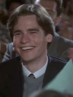 a young man smiling in front of an audience