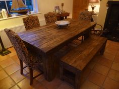 a dining room table with two benches in front of it