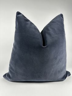 a dark blue pillow sitting on top of a white table