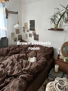 there is a bed in the room with brown sheets on it and a coffee cup next to it