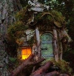 a tree stump with a small house built into it