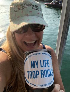 a woman holding up a cup with the words my life trip rocks on it