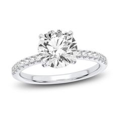 a diamond engagement ring on a white background