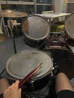 a person is playing drums on the floor