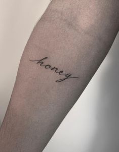 a man's arm with the word honey written in cursive writing on it