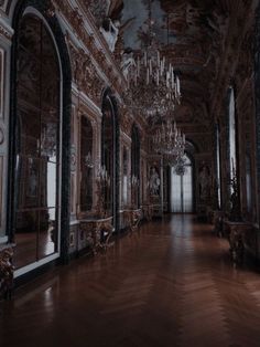 an ornate hallway with chandeliers and mirrors