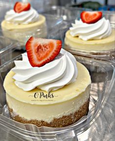 three desserts in plastic containers with strawberries on top