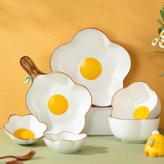 three eggs are sitting in bowls on a table