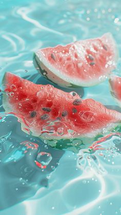 two slices of watermelon floating on top of the blue water with bubbles around them