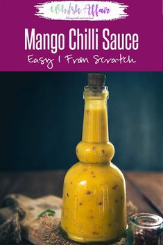 mango chilli sauce in a glass bottle on top of a wooden table with text overlay