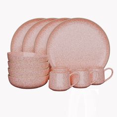 a set of pink dinnerware on a white background