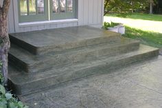 concrete steps leading up to the front door of a house