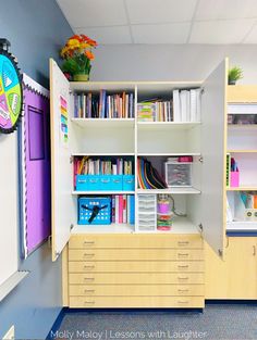 a room with many books and toys on shelves next to a wall clock that reads 1 25