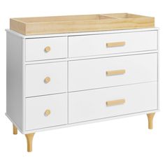 a white dresser with drawers and wooden handles