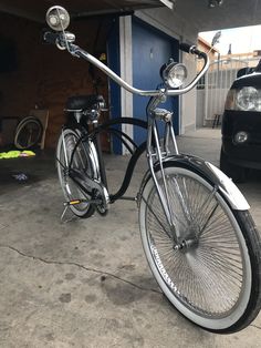 a bicycle parked in a garage next to a car