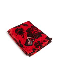 a red and black flowered handkerchief with the letter t on it's side