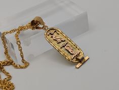 "18k Egyptian Scroll Hieroglyphic Scroll Pendant.  Unique Piece of Jewelry and History.  Exquisite Solid Gold Cartouche Pendant. Name : Jason Condition: Minimal signs of wear to its age Pendant: 18K Gold tested  Details on scroll or inserts 10k Rose Gold Weight of Pendant: 2.3 grams 38.5 mm length 11.7  mm wide  Complimentary 16\" Yellow 14k GF Necklace included. All our jewelry is properly washed and disinfected to ensure customers get clean items with every order. Comes in a beautiful gift box." Antique Gold Ankh Jewelry, Gold Rectangular Pendant Necklace Collectible, Gold Rectangular Pendant Necklace For Collectors, Gold Etched Rectangular Pendant Jewelry, Gold Rectangular Pendant With Etched Details, Collectible Etched Yellow Gold Jewelry, Gf Necklace, Egyptian Hieroglyphics, Beautiful Gift Boxes