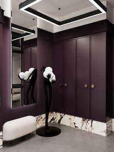 a bathroom with purple walls and marble flooring, two sculptures on pedestals in front of the mirror