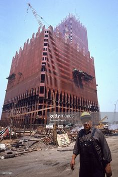 a man standing in front of a building under construction