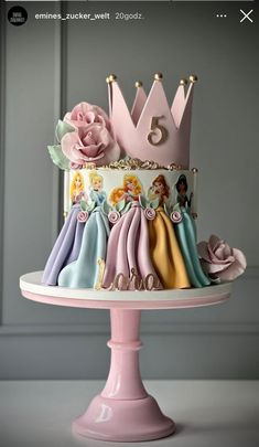 a cake decorated with princess crowns and flowers